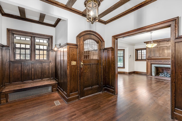 mudroom featuring wood walls, coffered ceiling, dark hardwood / wood-style floors, ornamental molding, and beamed ceiling