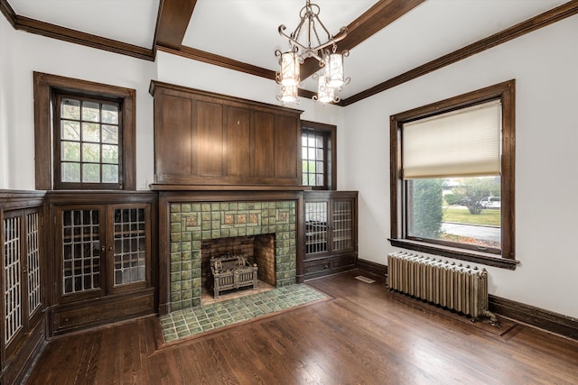 unfurnished living room featuring radiator, dark hardwood / wood-style flooring, and a healthy amount of sunlight