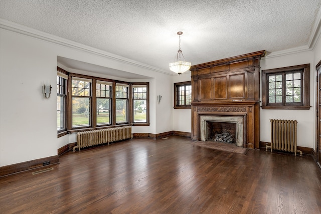 unfurnished living room with dark hardwood / wood-style flooring, radiator heating unit, a textured ceiling, and ornamental molding