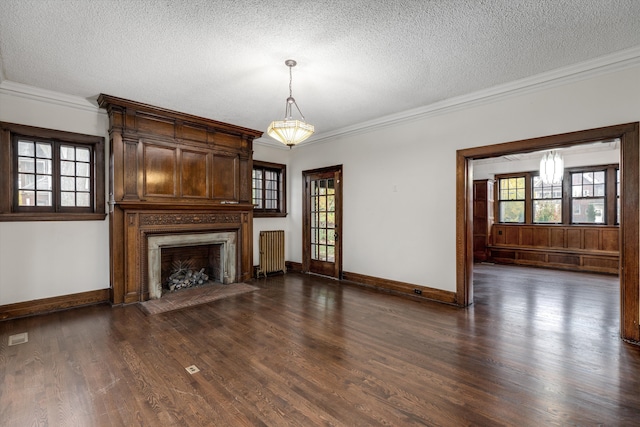 unfurnished living room with radiator, a textured ceiling, crown molding, a fireplace, and dark hardwood / wood-style floors