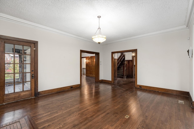 unfurnished room with dark hardwood / wood-style floors, ornamental molding, and a textured ceiling