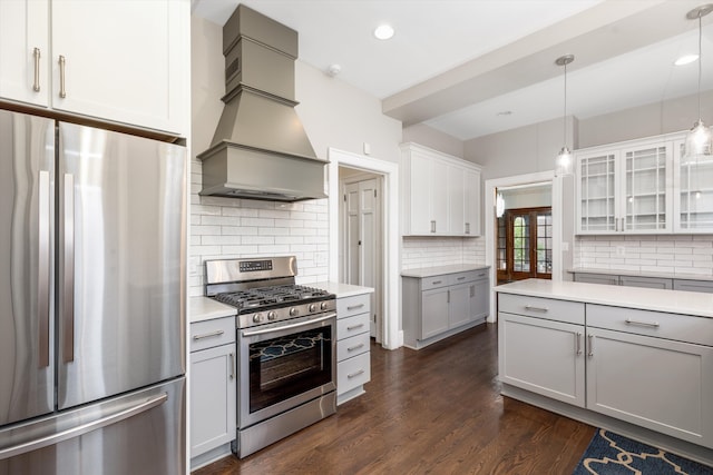 kitchen featuring dark hardwood / wood-style floors, decorative light fixtures, decorative backsplash, appliances with stainless steel finishes, and custom exhaust hood