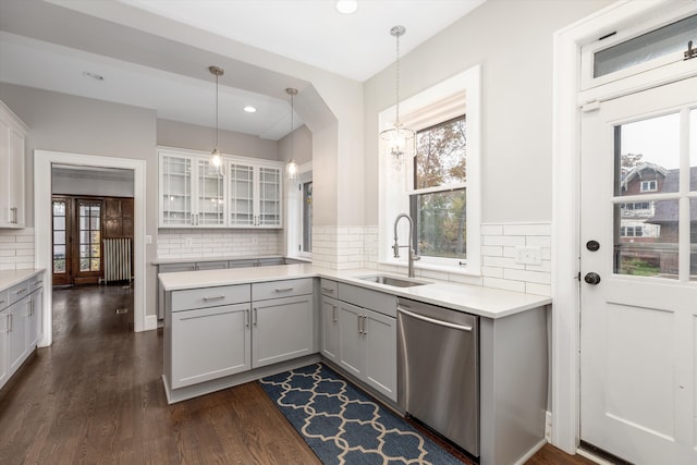 kitchen with decorative light fixtures, stainless steel dishwasher, a healthy amount of sunlight, and sink