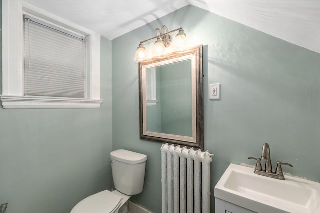 bathroom with vanity, toilet, and radiator