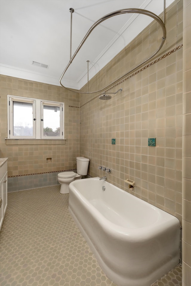 full bathroom featuring toilet, ornamental molding, tile walls, and shower / washtub combination