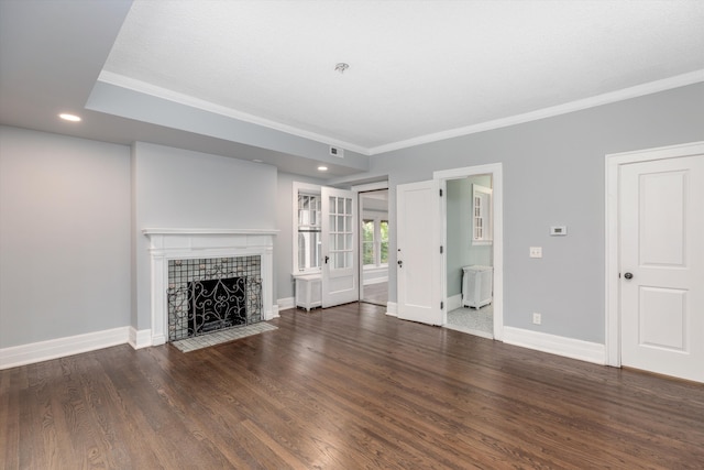 unfurnished living room featuring dark hardwood / wood-style floors, crown molding, and a tiled fireplace