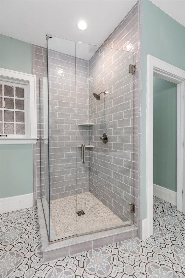 bathroom featuring tile patterned flooring and an enclosed shower