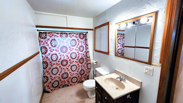 bathroom featuring a shower with curtain, vanity, and toilet