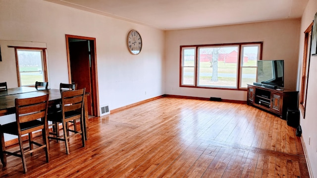 living room with plenty of natural light and light hardwood / wood-style flooring