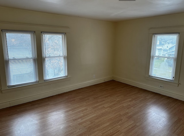 1707 E Stockbridge Ave, Kalamazoo, MI 49001 - empty room with plenty of natural light, wood finished floors, and baseboards