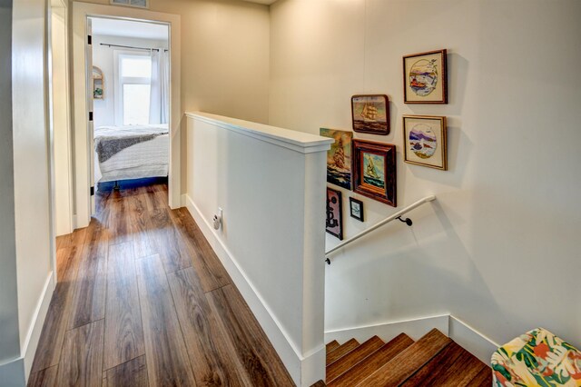 208 Gillis St, Traverse City, MI 49684 - hallway featuring an upstairs landing, dark wood-style flooring, and baseboards