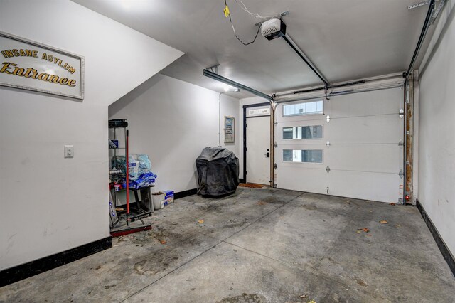 208 Gillis St, Traverse City, MI 49684 - garage featuring a garage door opener and baseboards
