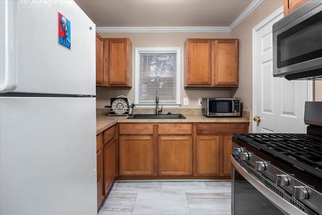 kitchen featuring crown molding, sink, and stainless steel appliances