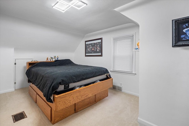 carpeted bedroom featuring lofted ceiling