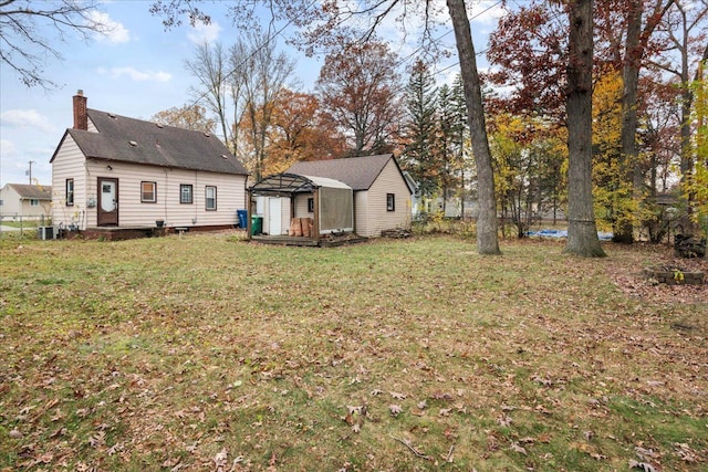 exterior space with a shed, central AC unit, and a lawn