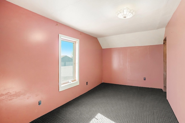 bonus room with carpet floors and lofted ceiling