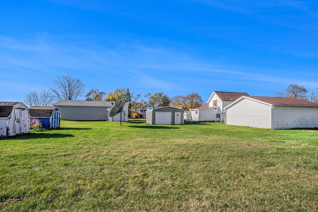 view of yard featuring a garage and a storage shed