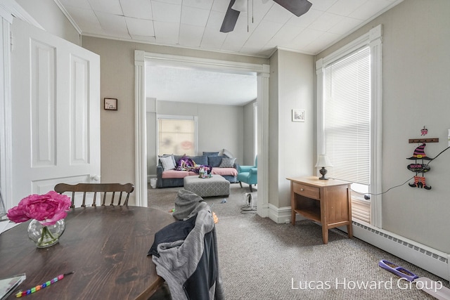 dining area with carpet flooring, ceiling fan, a healthy amount of sunlight, and baseboard heating