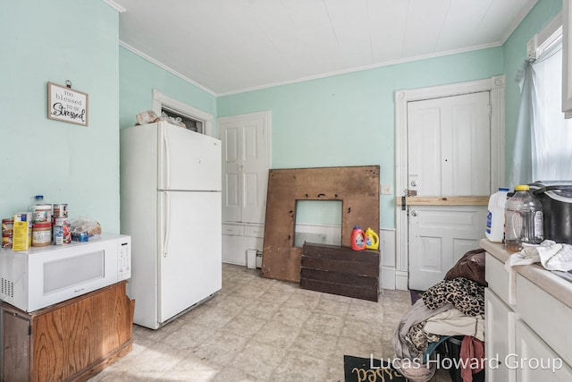 interior space with white fridge and crown molding