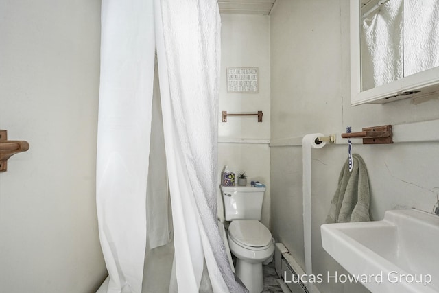 bathroom with walk in shower, sink, a baseboard radiator, and toilet