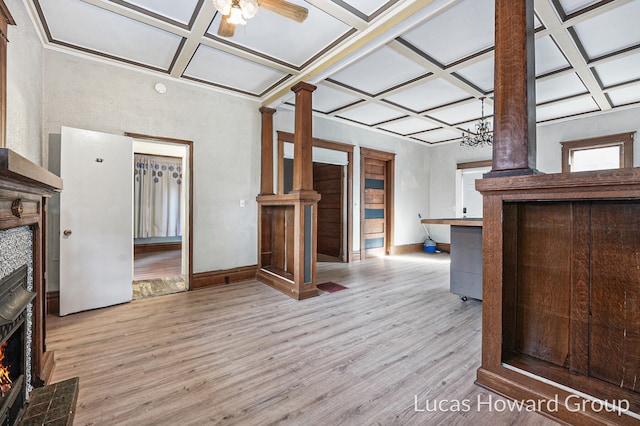 unfurnished living room with light hardwood / wood-style floors, ornate columns, ceiling fan, and coffered ceiling