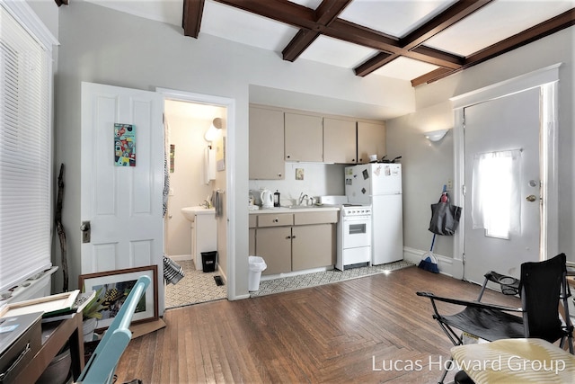 kitchen featuring coffered ceiling, white appliances, dark wood-type flooring, beam ceiling, and cream cabinets