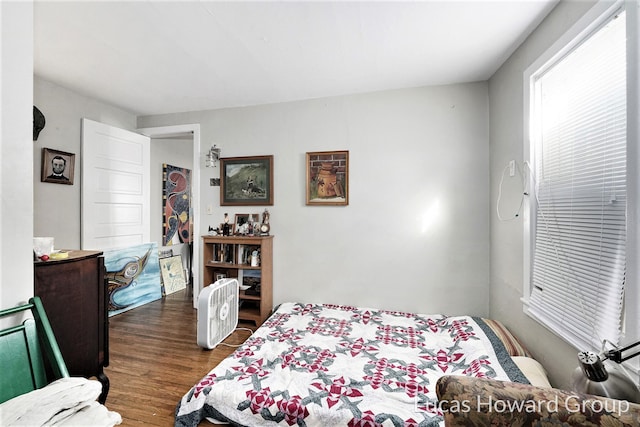 bedroom with dark hardwood / wood-style floors