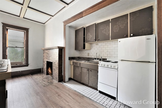 kitchen featuring coffered ceiling, a brick fireplace, white appliances, decorative backsplash, and light wood-type flooring