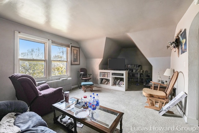 living room featuring radiator heating unit, carpet floors, and lofted ceiling