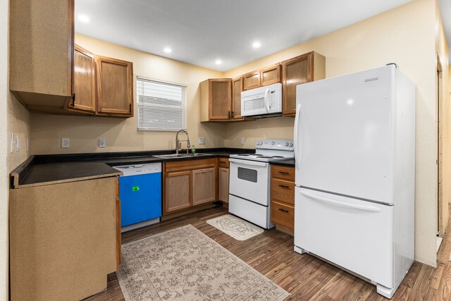 5393 Seebaldt St, Detroit, MI 48204 - kitchen with white appliances, a sink, dark wood-type flooring, dark countertops, and recessed lighting