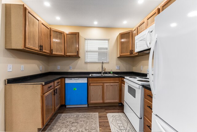 5393 Seebaldt St, Detroit, MI 48204 - kitchen with white appliances, a sink, dark wood-type flooring, dark countertops, and recessed lighting