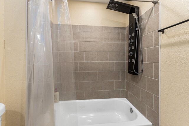 5393 Seebaldt St, Detroit, MI 48204 - bathroom with shower / tub combo, a textured wall, and pet washing station