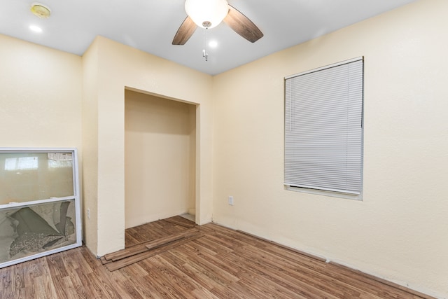 spare room with ceiling fan and wood-type flooring