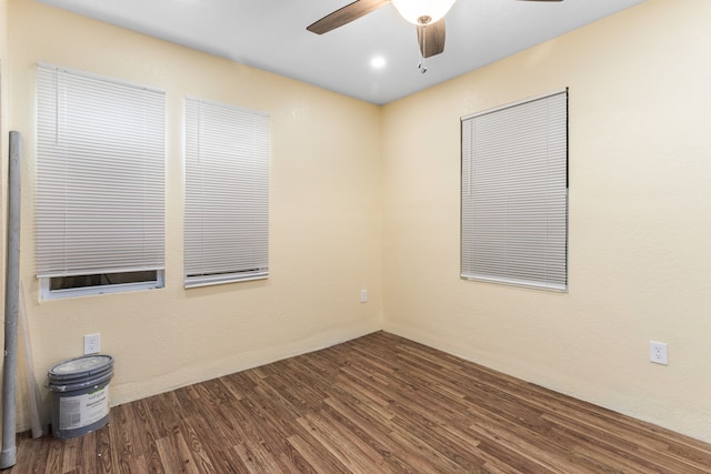 spare room with ceiling fan and dark wood-type flooring