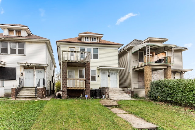 view of front of property featuring a balcony and a front yard