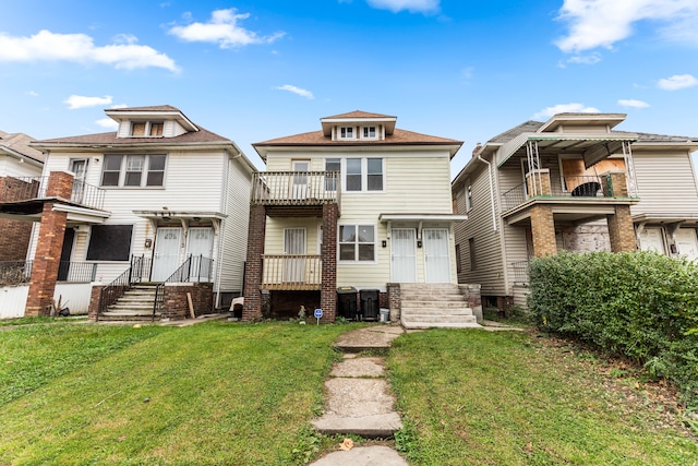 exterior space with a balcony and a front lawn