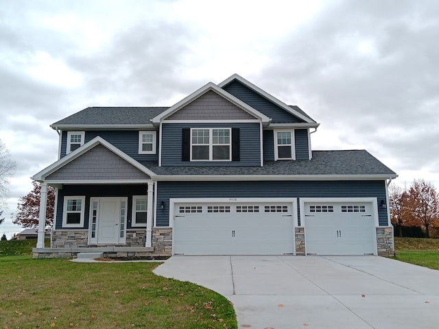 craftsman inspired home featuring a front lawn and a garage