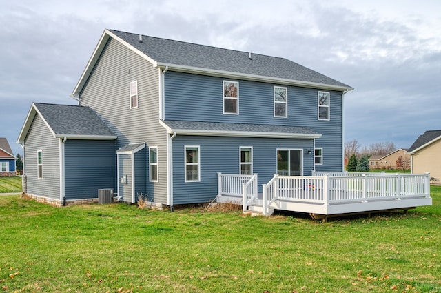 back of house featuring a lawn, central AC unit, and a wooden deck