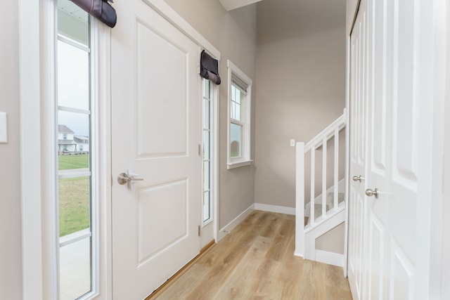 foyer entrance featuring a wealth of natural light and light hardwood / wood-style flooring