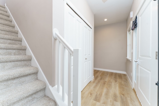 stairs with hardwood / wood-style flooring