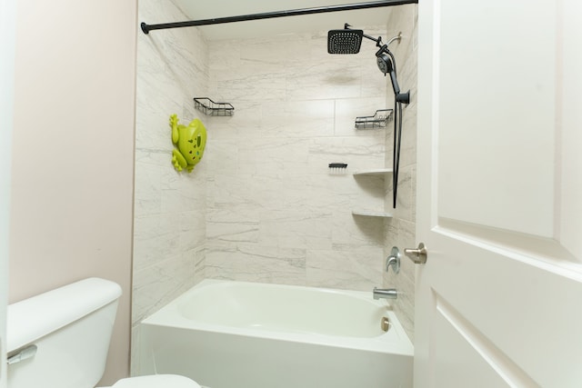 bathroom featuring tiled shower / bath and toilet