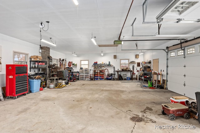 garage with a workshop area and a garage door opener