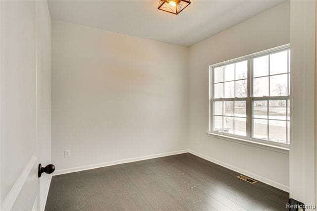 empty room with dark hardwood / wood-style floors