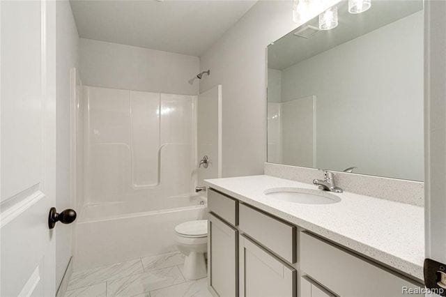 full bathroom featuring vanity, toilet, and shower / bath combination