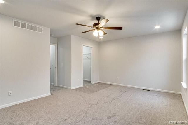 carpeted empty room with ceiling fan