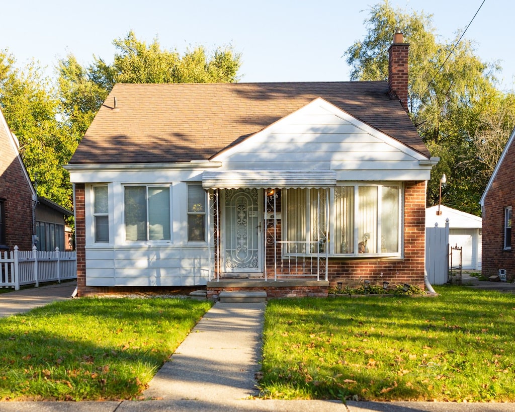 bungalow-style house with a front lawn