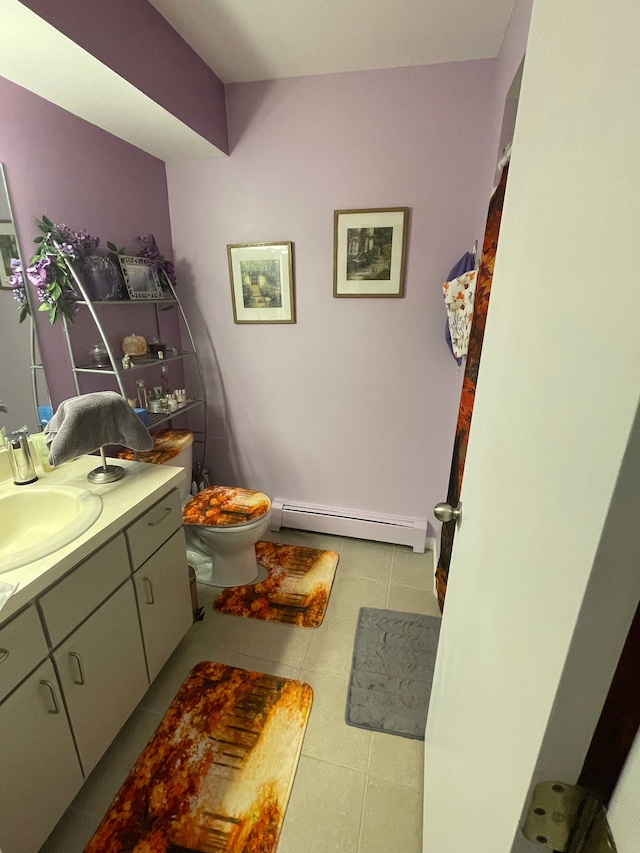 bathroom featuring tile patterned floors, vanity, toilet, and a baseboard radiator