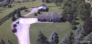 birds eye view of property with a rural view