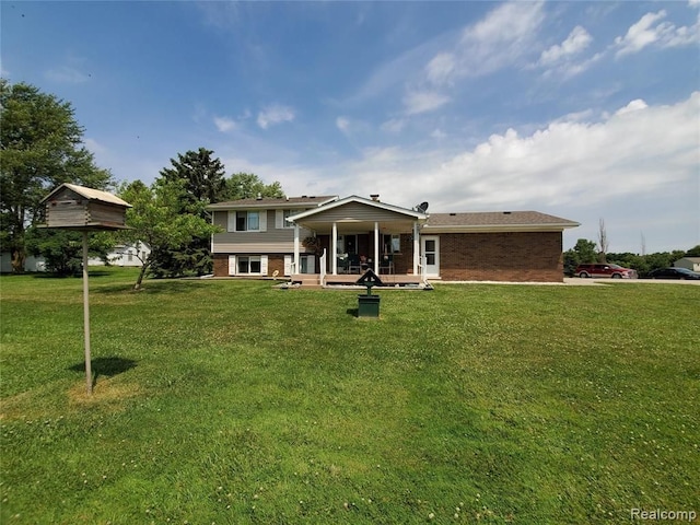 rear view of house featuring a lawn