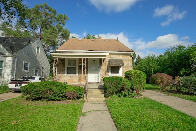 bungalow-style home featuring a front yard